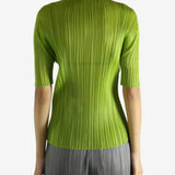 Green shirt worn by a person, showing the shirt's fit