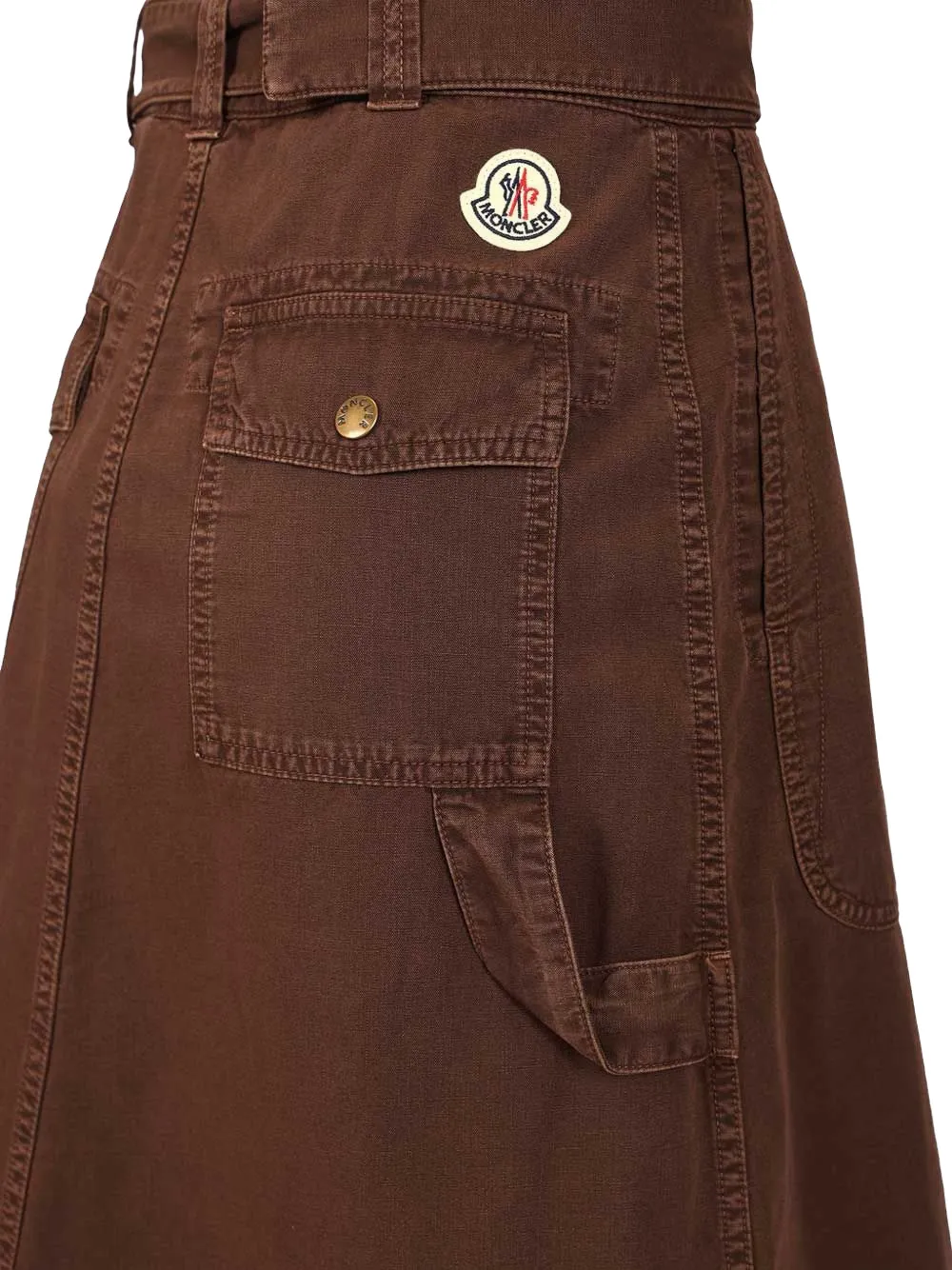 Close up of brown skirt, showing the logo pin detials