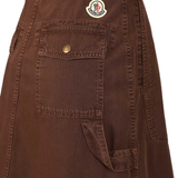 Close up of brown skirt, showing the logo pin detials