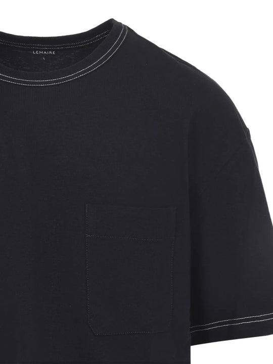 Close up of black t-shirts, showing texture of the cotton fabric