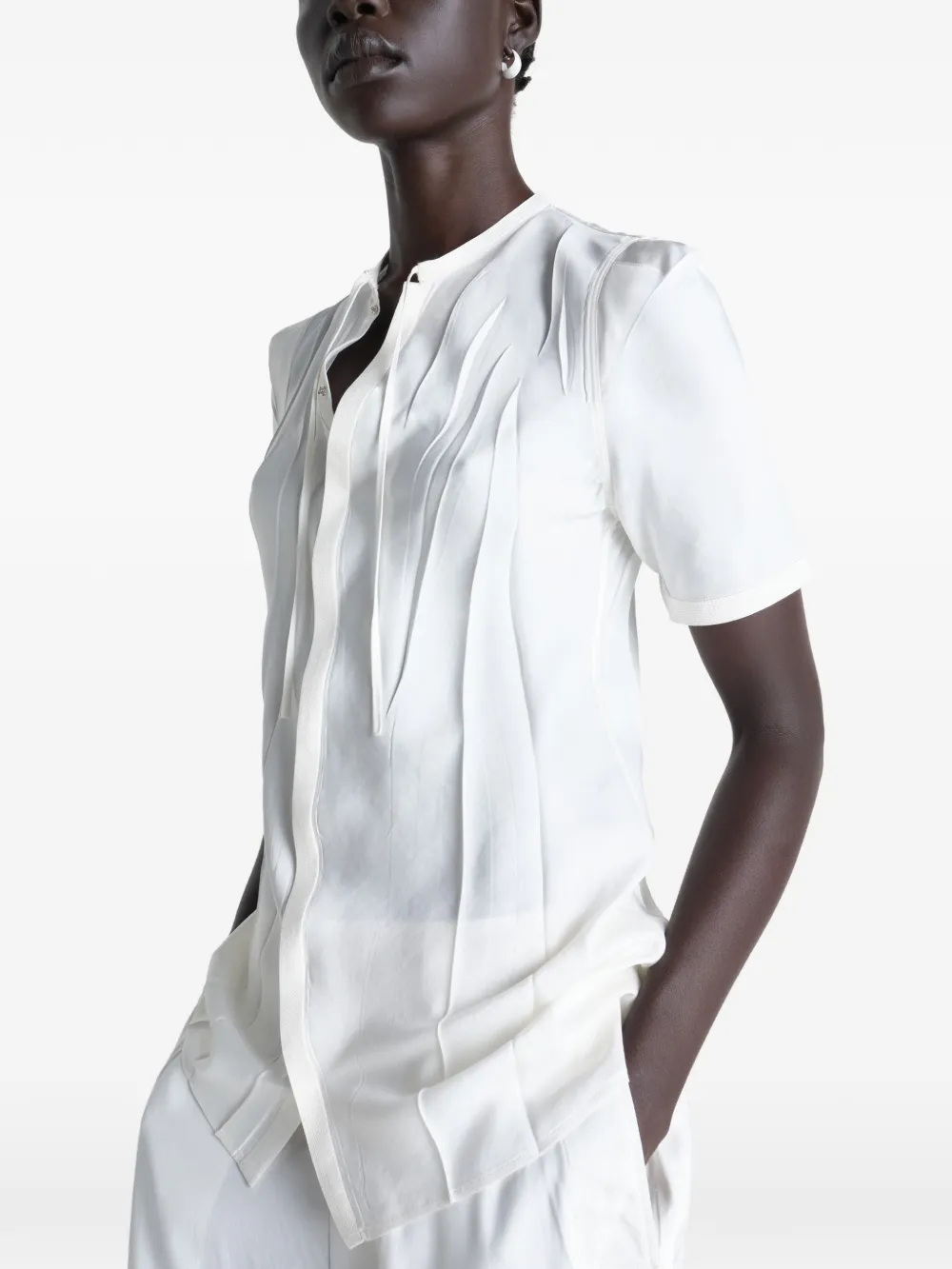 White shirt worn by a person, showing the shirt's fit