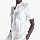 White shirt worn by a person, showing the shirt's fit