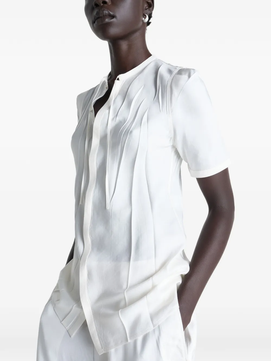 White shirt worn by a person, showing the shirt's fit