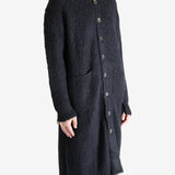 Black coat worn by a person, showing the coat's fit