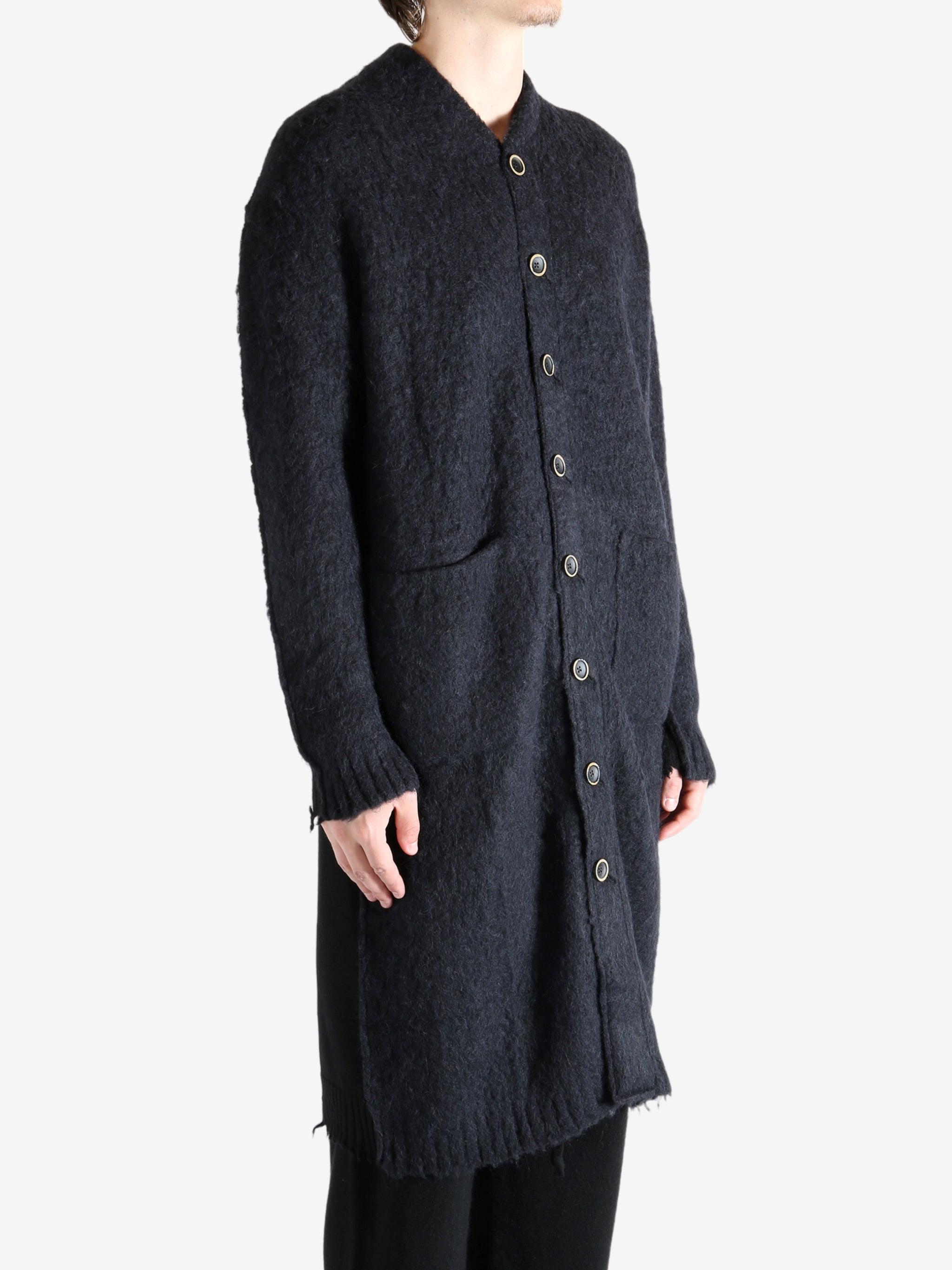 Black coat worn by a person, showing the coat's fit