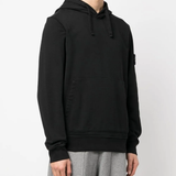 Black sweater worn by a person, showing the sweater's fit