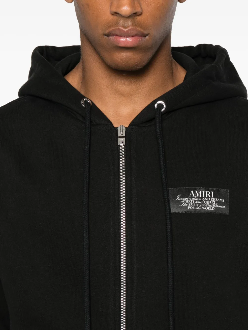 Close up of the black hoodie, showing texture of the cotton fabric
