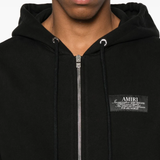 Close up of the black hoodie, showing texture of the cotton fabric