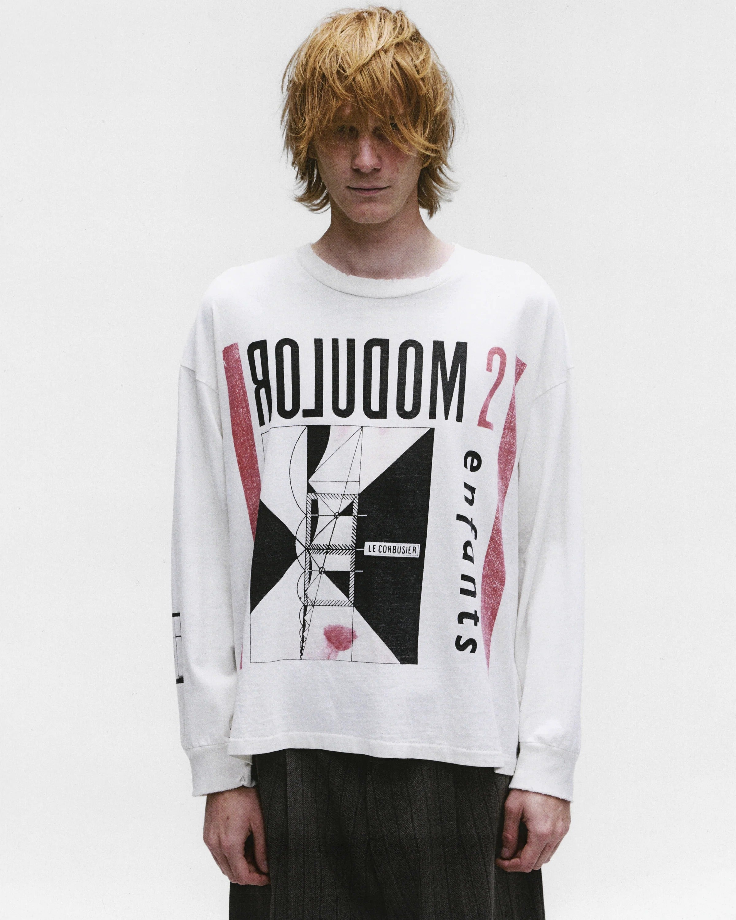 White t-shirt worn by a person, showing the shirt's fit