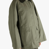 Green coat worn by a person, showing the loose fit.