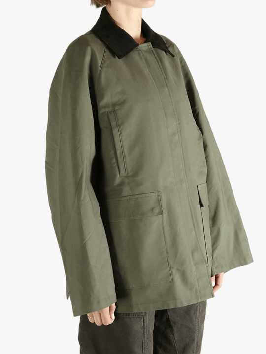 Green coat worn by a person, showing the loose fit.