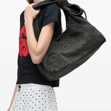 black bags worn by a person, showing the bags fit