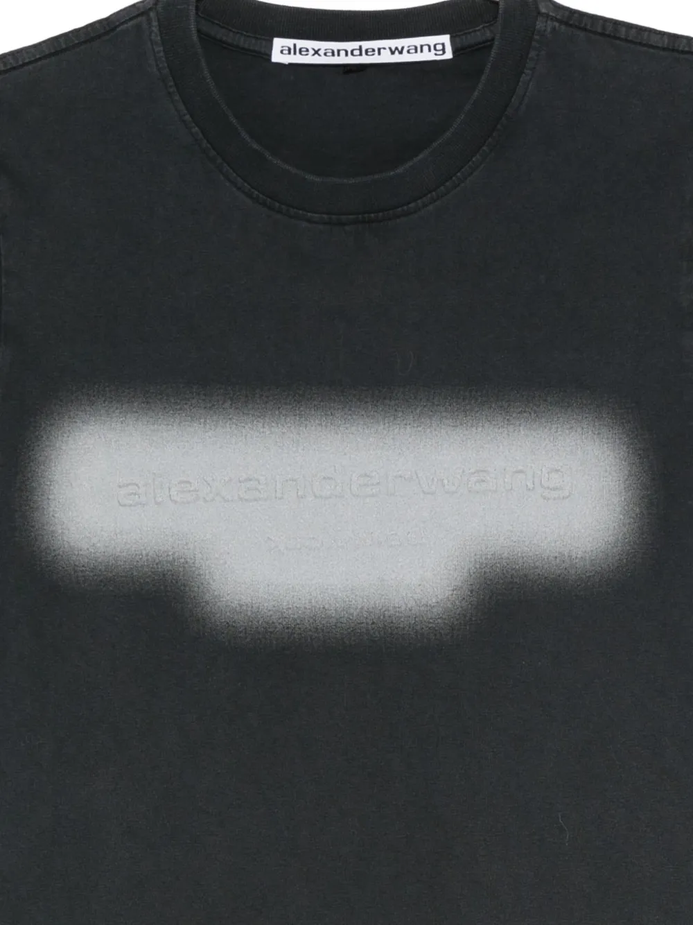 Close up of black t-shirt, showing texture of the Cotton fabric