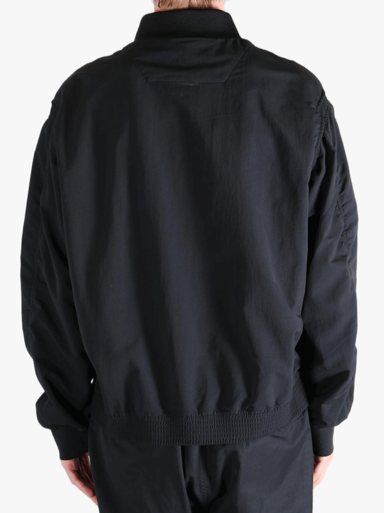 Black jackets worn by a person, showing the jackets fit