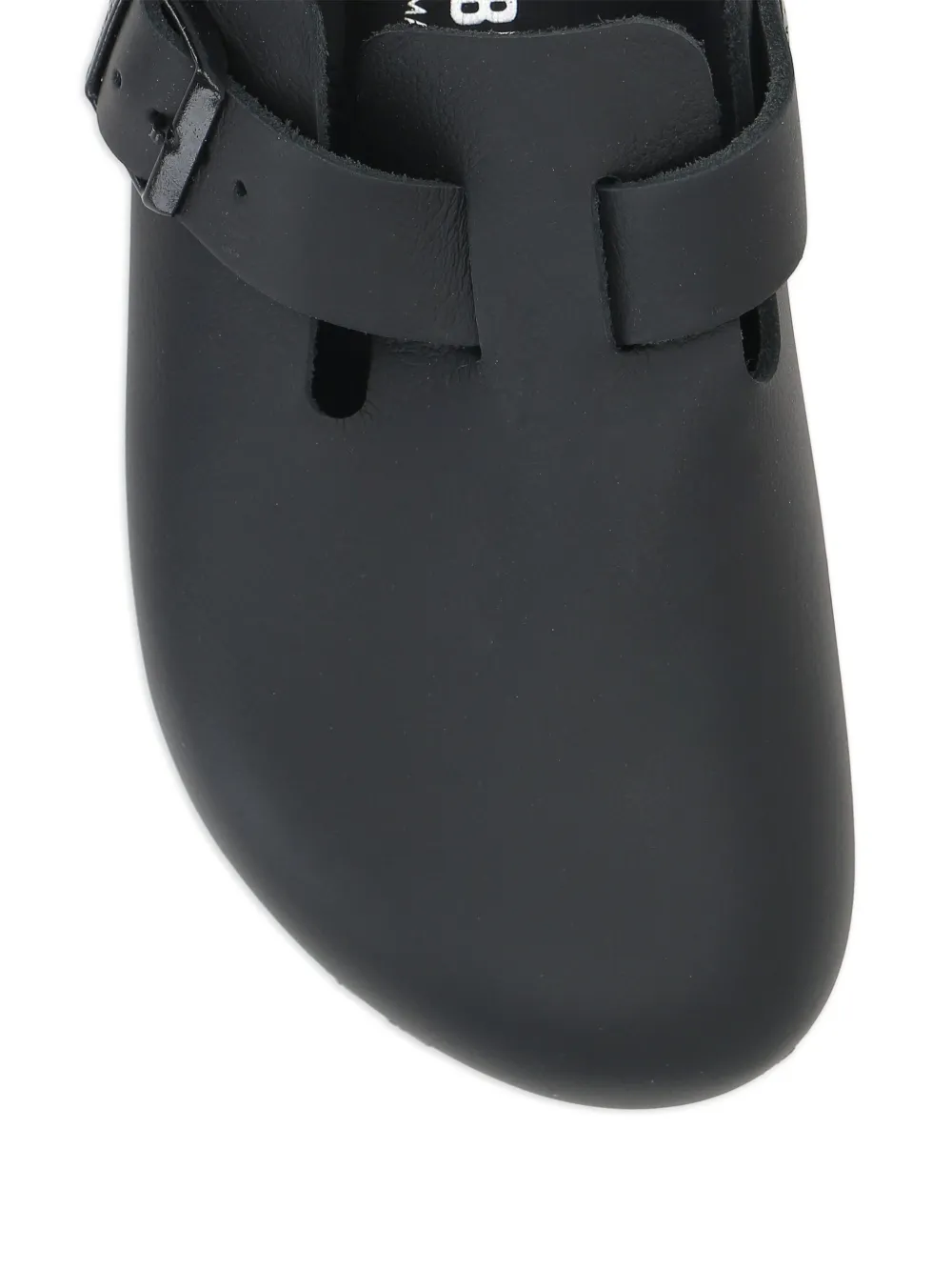 Close up of black sandals,showing texture of the leather fabric.