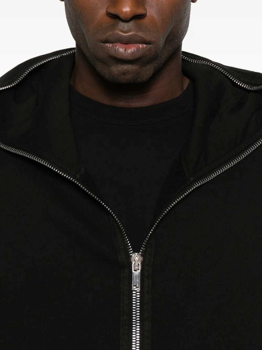 Close up of the black hoodie, showing texture of the cotton fabric