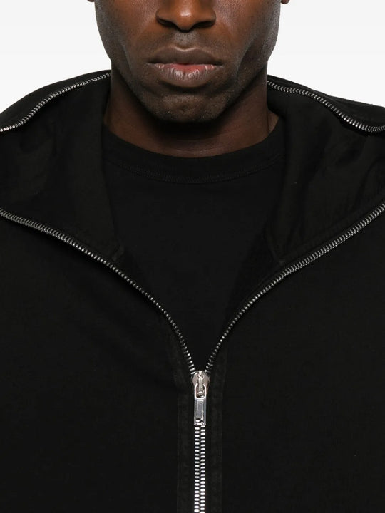 Close up of the black hoodie, showing texture of the cotton fabric
