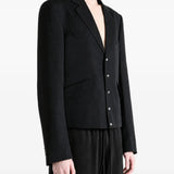 Black jacket worn by a person, showing the jacket fit