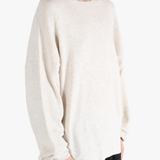 White sweater worn by a person, showing the sweater's fit