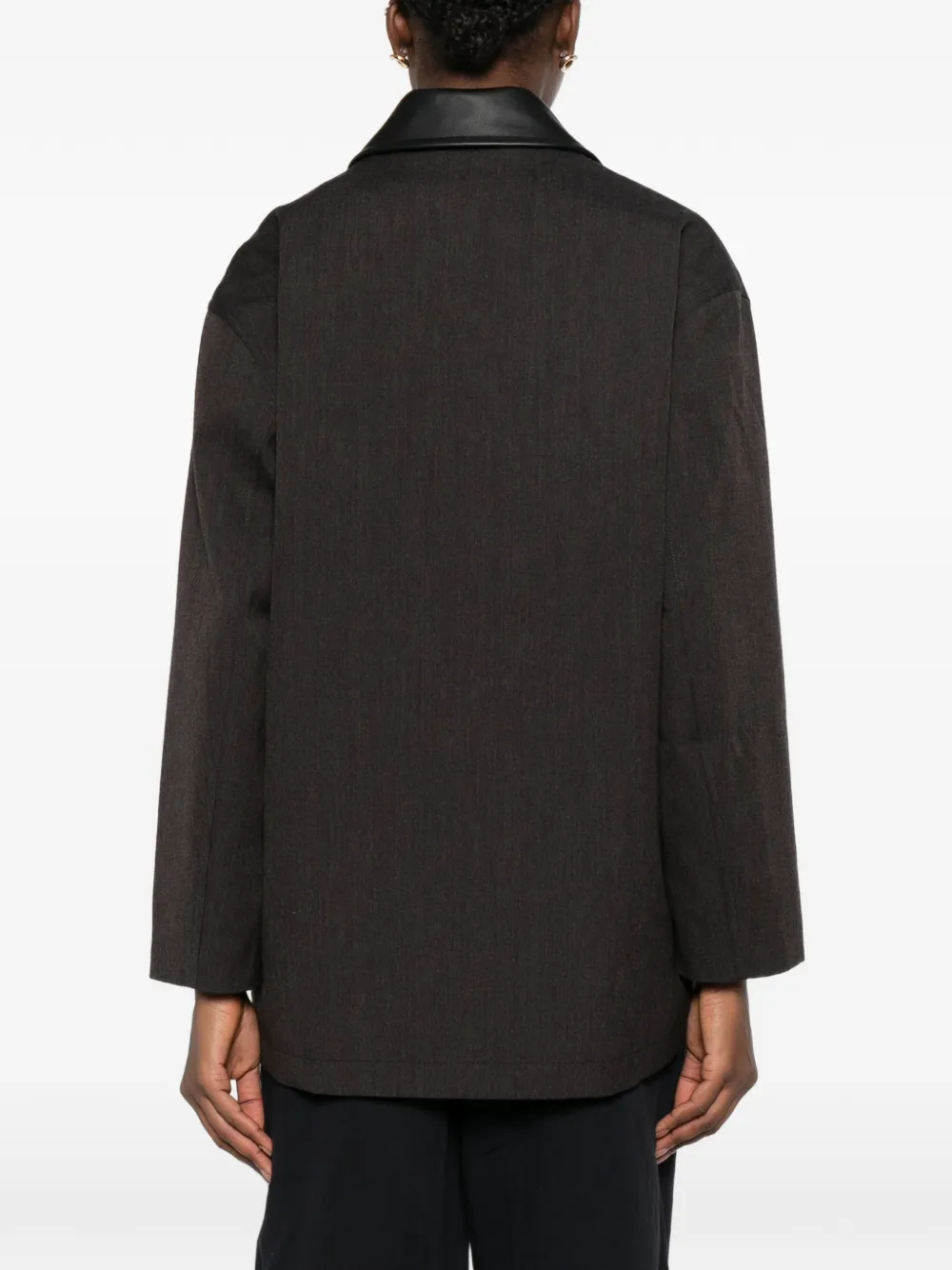 brown jackets-coats worn by a person, showing the  jackets-coats fit