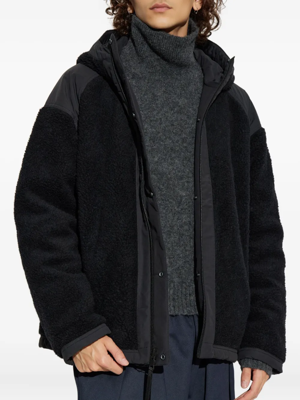 Black jacket worn by a person, showing the jacket fit