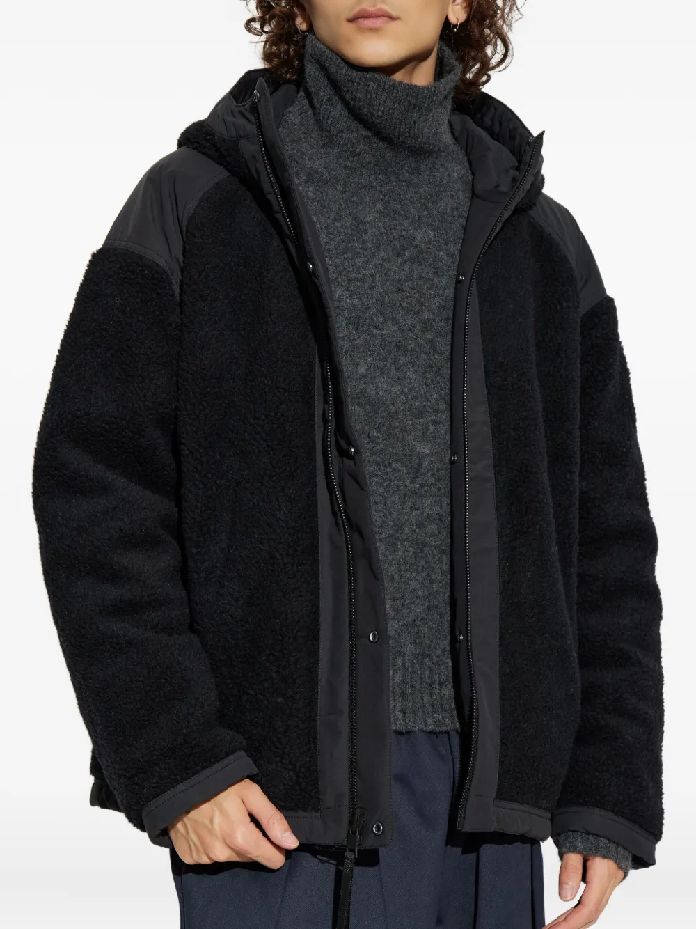 Black jacket worn by a person, showing the jacket fit