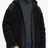 Black jacket worn by a person, showing the jacket fit