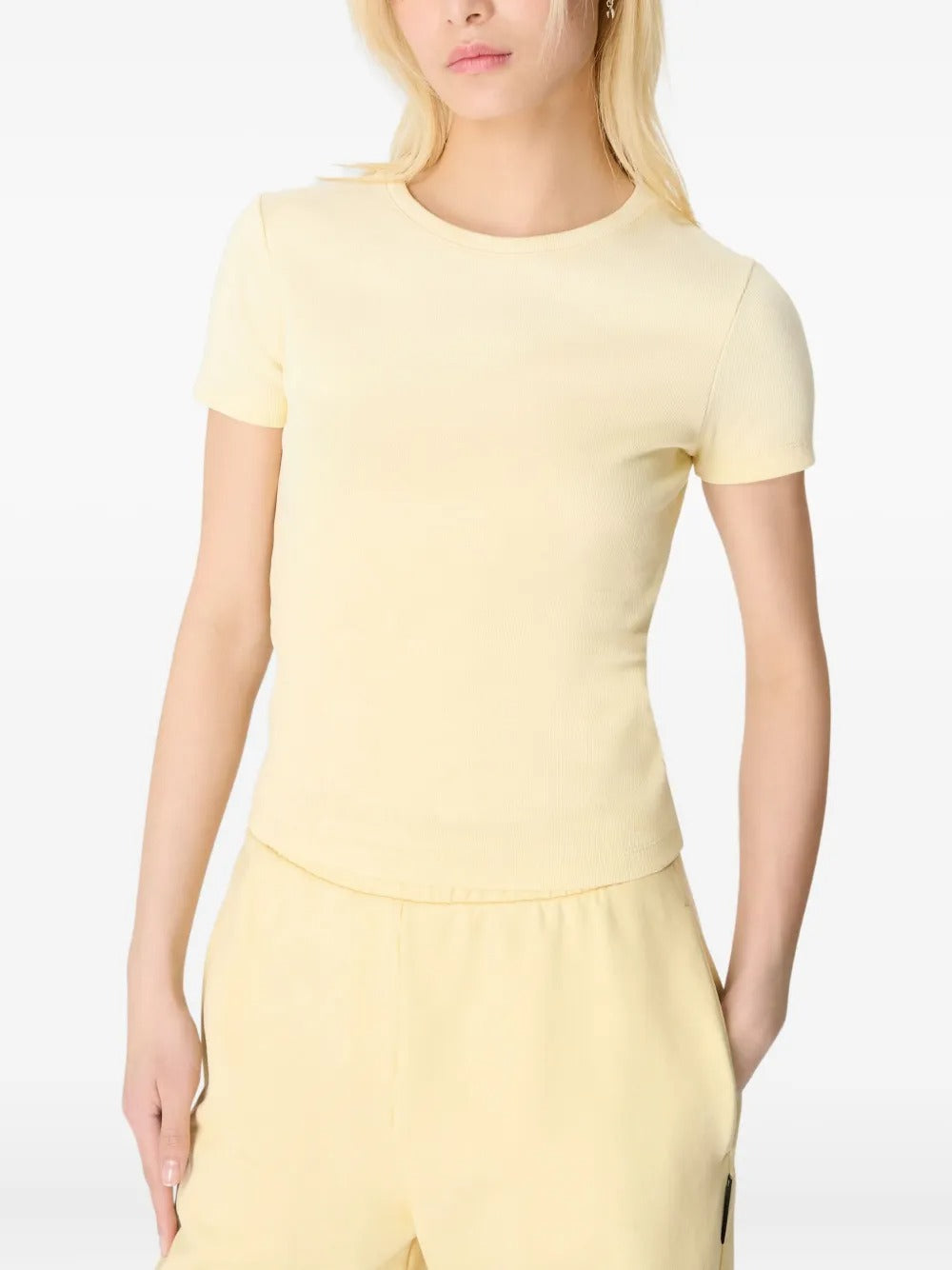 Yellow t-shirt worn by a person, showing the shirt's fit