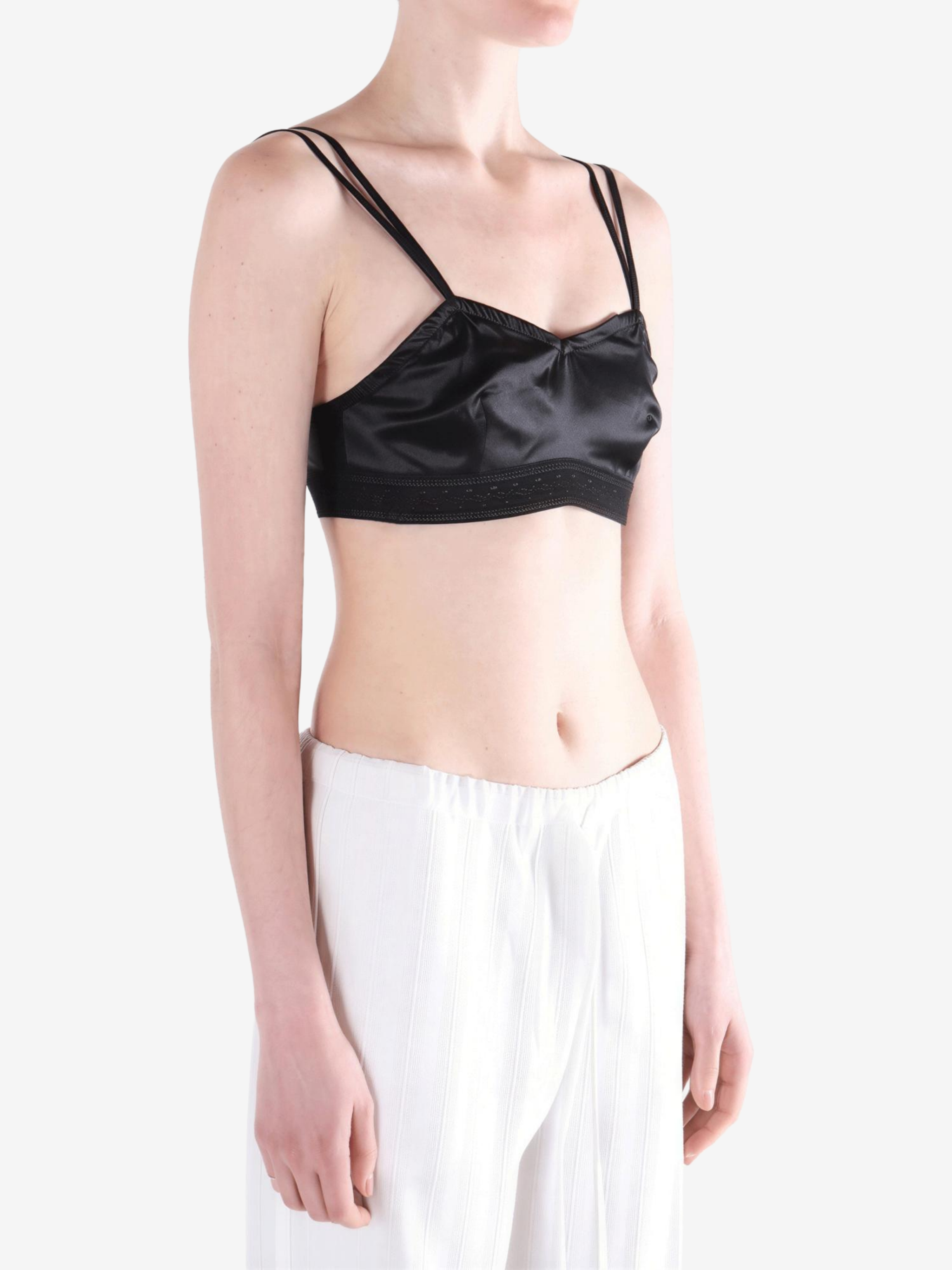 Black top worn by a person, showing the top fit