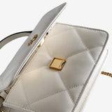 Close up of the white bag, showing texture of the leather fabric