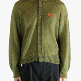 Green cardigan worn by a person, showing the cardigan's fit