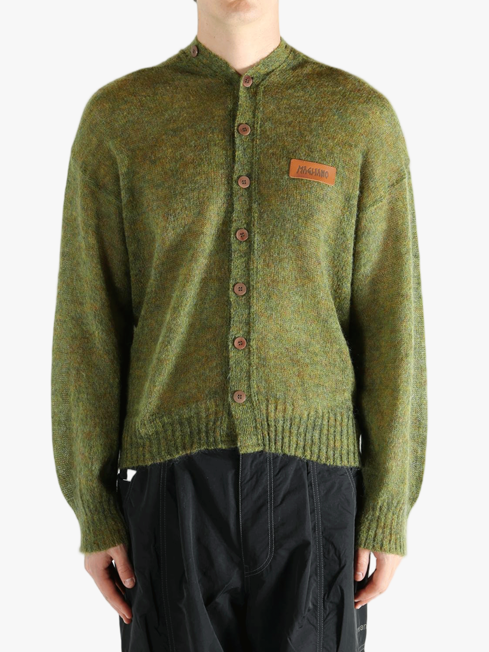 Green cardigan worn by a person, showing the cardigan's fit