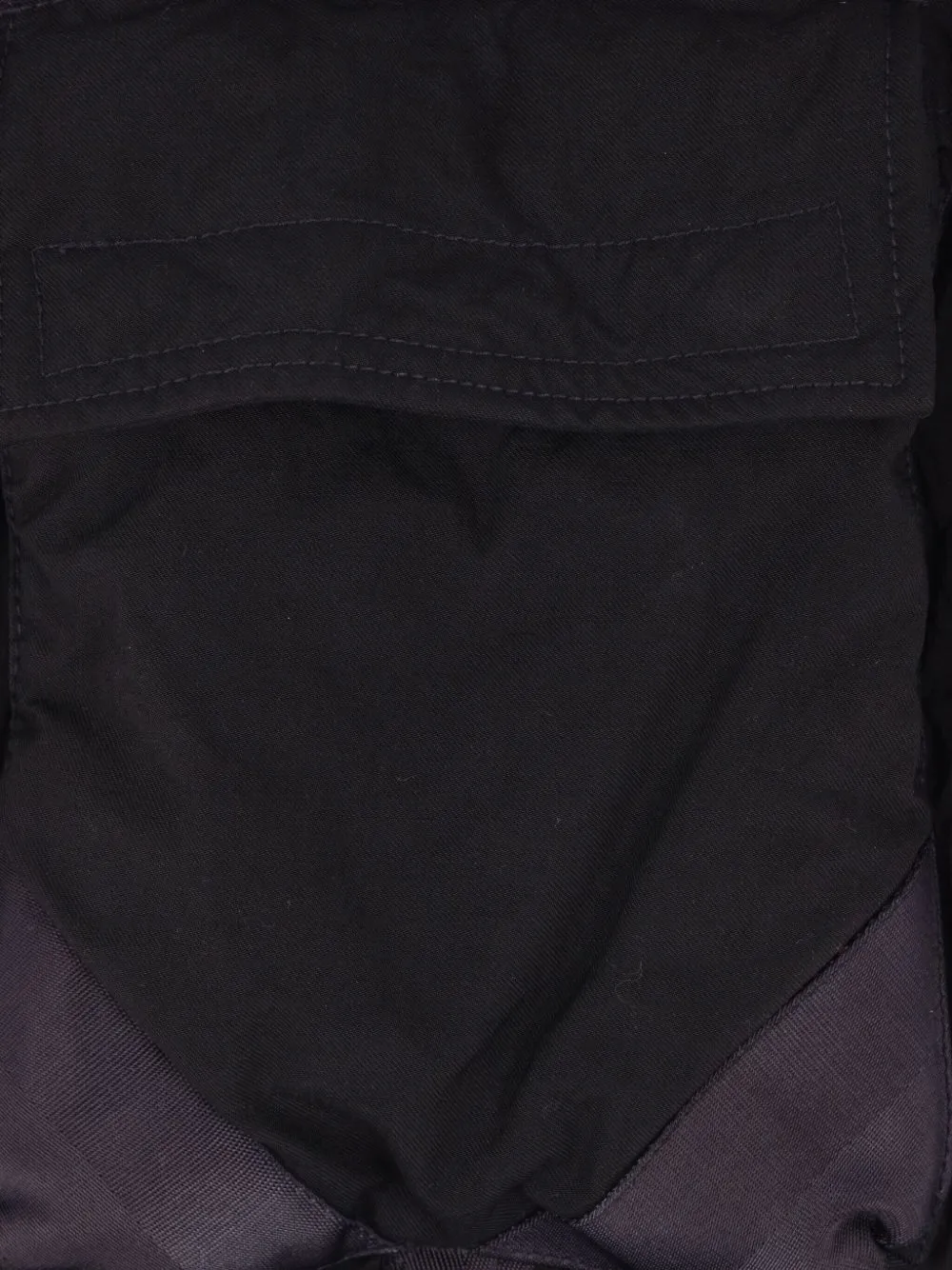 Close up of the black jacket, showing texture of the polyamide fabric