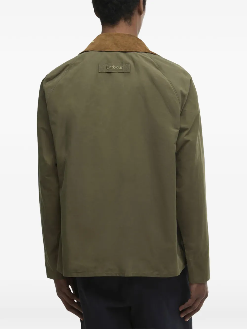 Green jacket worn by a person, showing the jacket's fit