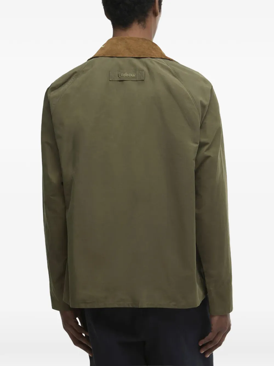 Green jacket worn by a person, showing the jacket's fit
