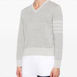 Grey knitwear worn by a person, showing the knitwear’s fit