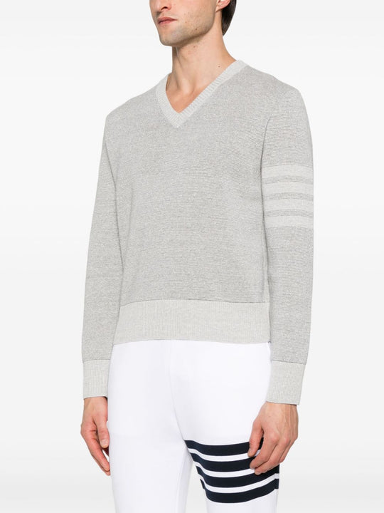 Grey knitwear worn by a person, showing the knitwear’s fit