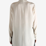 White top worn by a person, showing the top's fit