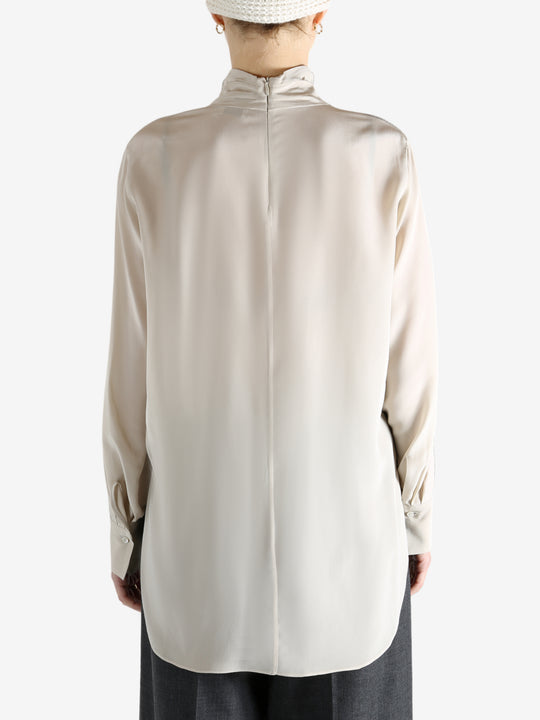 White top worn by a person, showing the top's fit