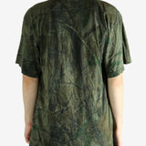 Green t-shirt worn by a person, showing the t-shirt's fit