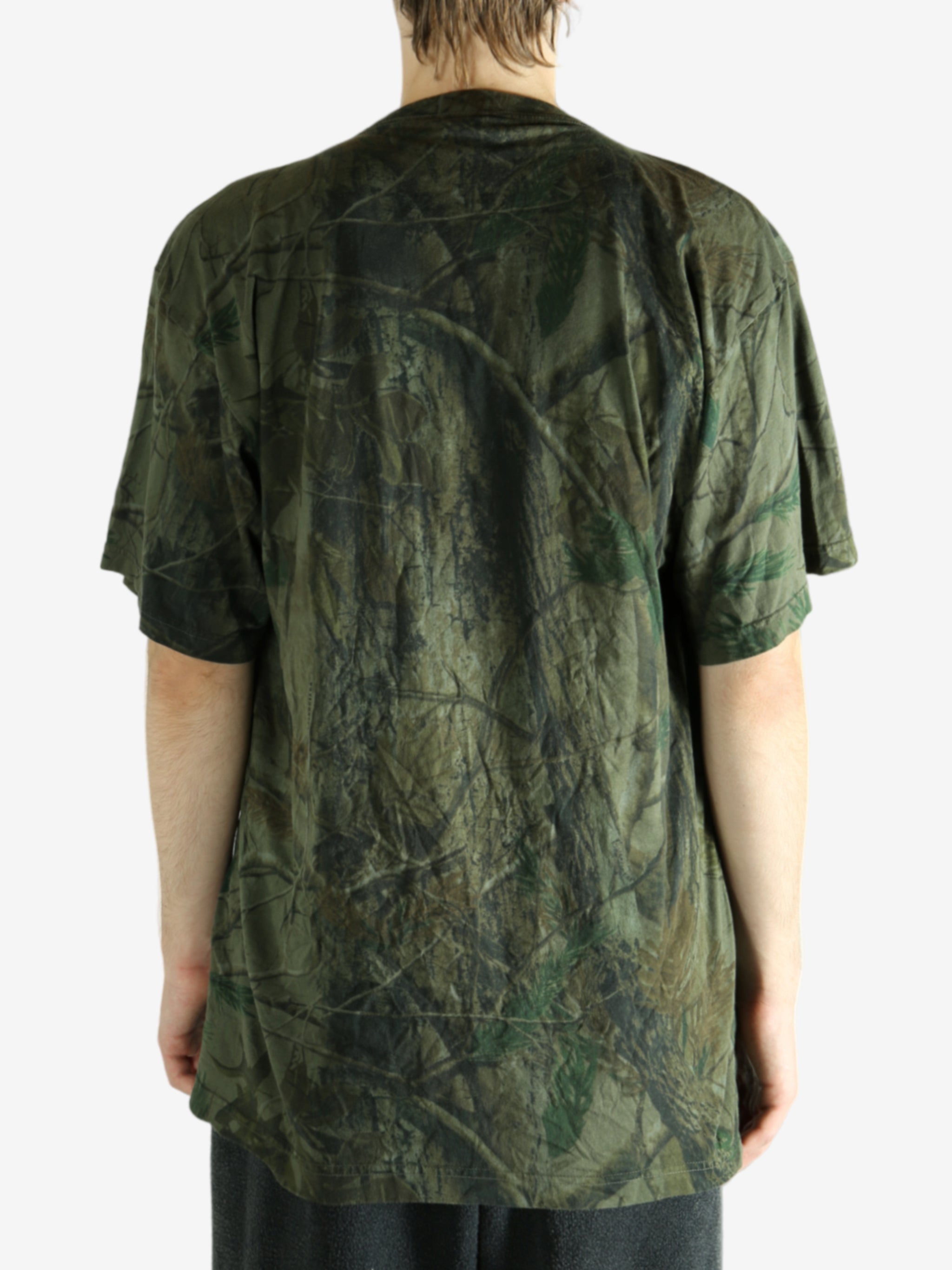 Green t-shirt worn by a person, showing the t-shirt's fit