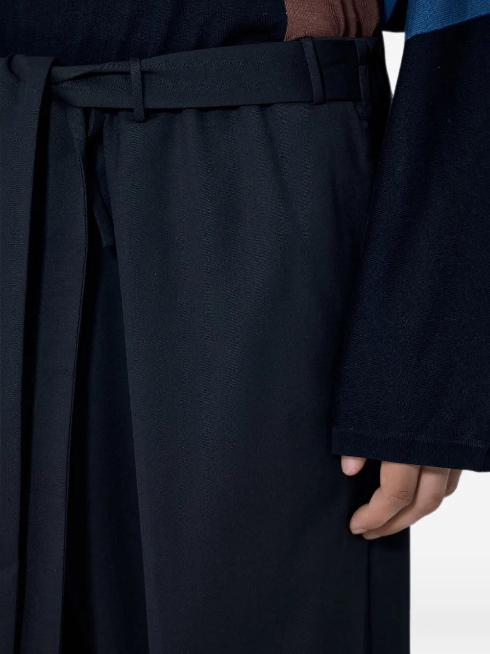 Black pants worn by a person, showing the pants fit