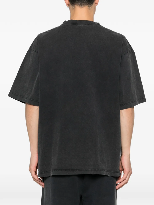 black t-shirt worn by a person, showing the t-shirt fit