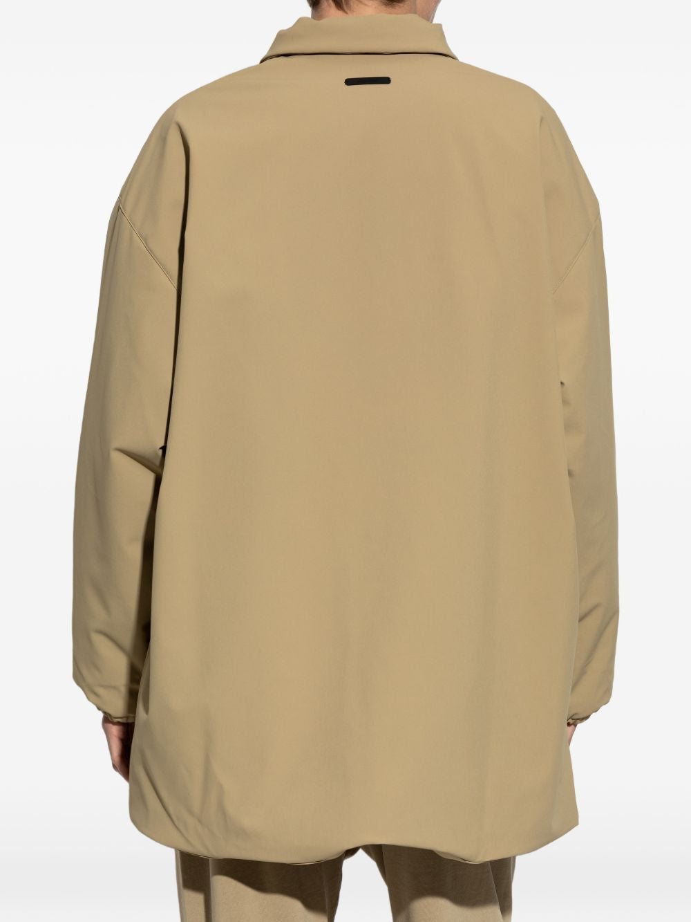 Tan jacket worn by a person, showing the jacket's fit