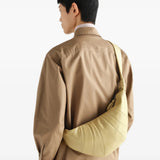 Tan bag worn by a person, showing the bag fit