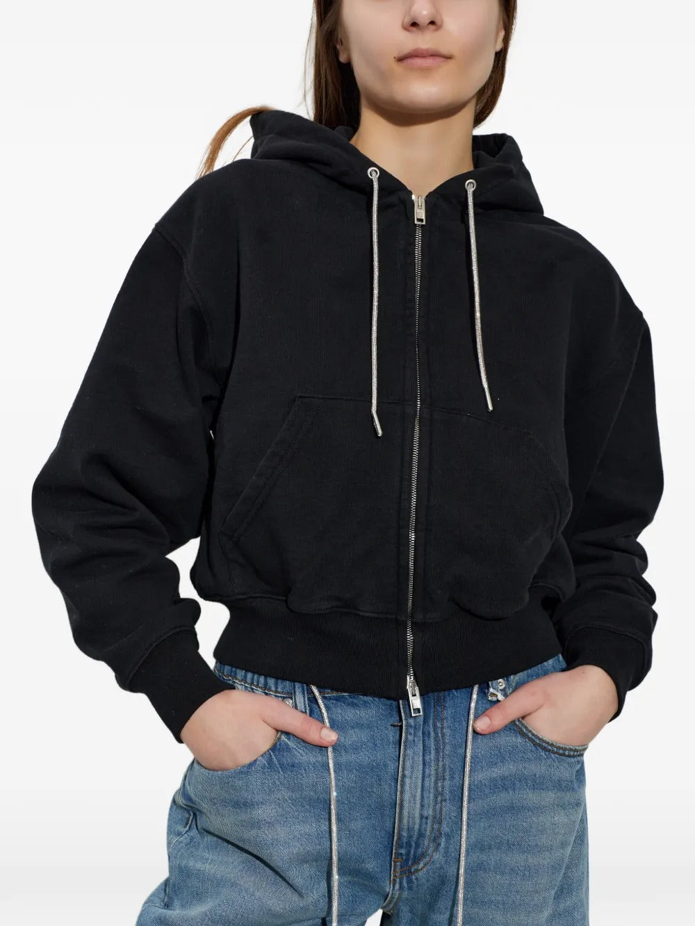 Black hoodie worn by a person, showing the hoodie's fit