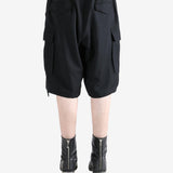 Black pants worn by a person, showing the pants's fit