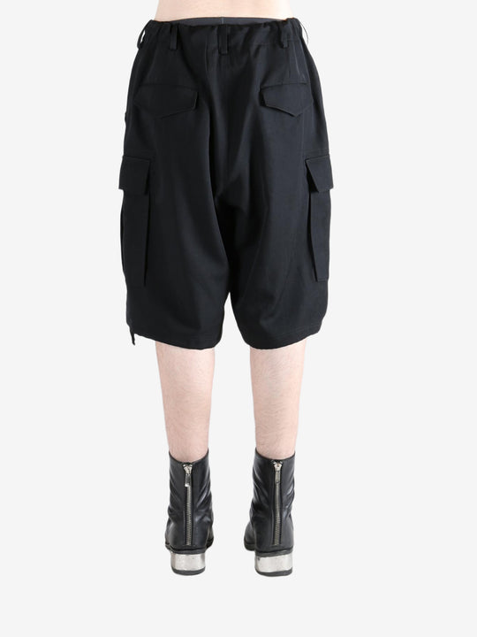 Black pants worn by a person, showing the pants's fit