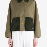 Green jacket worn by a person, showing the jacket fit