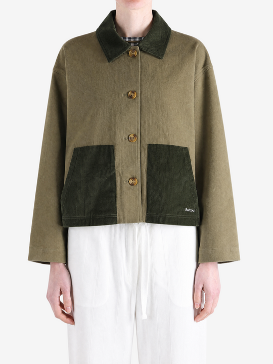 Green jacket worn by a person, showing the jacket fit